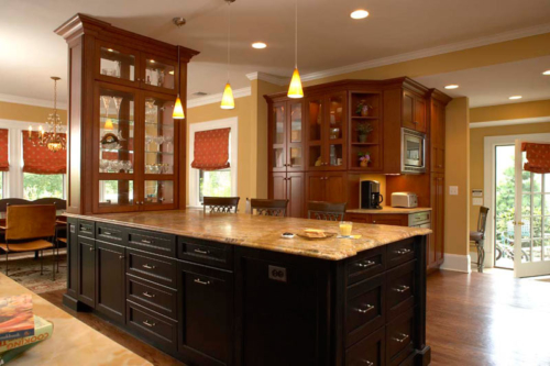 Remodeled citchen with glass cabinets, granite-topped island with dark wood stain.